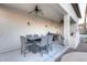 Covered patio with dining table, ceiling fans, and outdoor kitchen area, perfect for entertaining at 8026 W Villa Lindo Dr, Peoria, AZ 85383