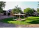 A well-maintained community park features a covered picnic area with lush landscaping and mature trees at 8026 W Villa Lindo Dr, Peoria, AZ 85383