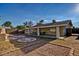 An outdoor patio with custom stonework that features covered seating and drought-resistant landscaping at 1045 S Solomon St, Mesa, AZ 85204