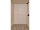 A walk-in shower featuring white horizontal tiles and a unique mosaic tile floor at 1045 S Solomon St, Mesa, AZ 85204