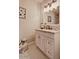 Updated bathroom featuring white vanity, neutral walls, and penny tile flooring at 1045 S Solomon St, Mesa, AZ 85204