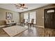 Inviting living room with wood floors, ceiling fan, neutral walls, and plenty of natural light at 1045 S Solomon St, Mesa, AZ 85204