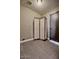 A room with gray tiled flooring and a decorative privacy screen next to a dark door at 1045 S Solomon St, Mesa, AZ 85204