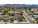 Aerial view of neighborhood featuring mature landscaping, pools, and mountain views at 10590 E Mercer Ln, Scottsdale, AZ 85259