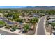 Aerial view of neighborhood featuring mature landscaping, pools, and mountain views at 10590 E Mercer Ln, Scottsdale, AZ 85259