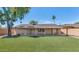 Beautiful backyard with an artificial grass lawn and covered patio at 10590 E Mercer Ln, Scottsdale, AZ 85259
