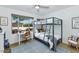 Cozy bedroom featuring a bunk bed, desk, and a window overlooking the front yard at 10590 E Mercer Ln, Scottsdale, AZ 85259