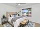 Well-lit bedroom with a large window and stylish furniture at 10590 E Mercer Ln, Scottsdale, AZ 85259