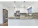 Updated kitchen with granite countertops, stainless steel appliances, and sleek white cabinetry at 10590 E Mercer Ln, Scottsdale, AZ 85259