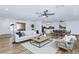 Bright, open-concept living room featuring modern furnishings and wood-look tile flooring at 10590 E Mercer Ln, Scottsdale, AZ 85259