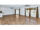 Large living area with wood-look tile flooring, abundant natural light, ceiling fan, and backyard view at 10590 E Mercer Ln, Scottsdale, AZ 85259