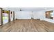 Spacious and bright living area featuring wood-look tile flooring, and backyard view at 10590 E Mercer Ln, Scottsdale, AZ 85259
