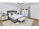 Serene main bedroom with neutral tones, ceiling fan, and French doors to outdoor space at 10590 E Mercer Ln, Scottsdale, AZ 85259