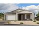 Charming single-story home featuring a two-car garage, neutral color palette, and a welcoming front porch at 11338 E Utah Ave, Mesa, AZ 85212