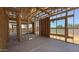 Open-concept home with wooden framing offering a bright living space and views of the expansive backyard at 11338 E Utah Ave, Mesa, AZ 85212