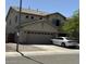 Two-story home with a two-car garage and a low-maintenance desert landscape at 11633 W Jefferson St, Avondale, AZ 85323