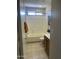 Bathroom featuring a wood vanity, toilet, shower and picturesque artwork at 12138 W Flores Dr, El Mirage, AZ 85335