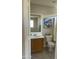 Bathroom featuring a wood vanity, toilet, shower and picturesque artwork at 12138 W Flores Dr, El Mirage, AZ 85335