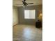 Comfortable bedroom featuring tile floors, a ceiling fan, and a side table with lamp at 12138 W Flores Dr, El Mirage, AZ 85335