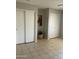 Bedroom view featuring tile floors, closet and neutral color scheme at 12138 W Flores Dr, El Mirage, AZ 85335