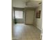 This bedroom features a ceiling fan, window and tile flooring at 12138 W Flores Dr, El Mirage, AZ 85335