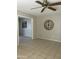 Living room featuring neutral paint, tile floors, and an arched doorway for an open feel at 12138 W Flores Dr, El Mirage, AZ 85335