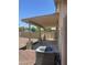 Covered patio featuring a built-in BBQ and rock-scaped yard at 12138 W Flores Dr, El Mirage, AZ 85335