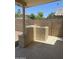 Covered patio featuring a built-in BBQ and rock-scaped yard at 12138 W Flores Dr, El Mirage, AZ 85335