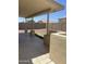 Covered patio featuring a built-in BBQ and rock-scaped yard at 12138 W Flores Dr, El Mirage, AZ 85335