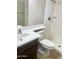 Neat bathroom with white toilet and sink adjacent to a shower at 1304 E Hackamore St, Mesa, AZ 85203