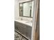 Bathroom view with stylish vanity, double sinks, and a sliding barn door, all complementing the unique pebble flooring at 1304 E Hackamore St, Mesa, AZ 85203