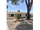 Exterior view of a charming single-story home with desert landscaping and mature trees at 1304 E Hackamore St, Mesa, AZ 85203