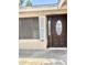 Inviting front entrance with a dark wood door, storm door, and security screen, enhanced by a tiled porch at 1304 E Hackamore St, Mesa, AZ 85203