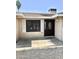 Inviting front entrance with a dark wood door, storm door, and security screen, enhanced by a tiled porch at 1304 E Hackamore St, Mesa, AZ 85203
