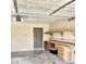 Well-lit garage with a convenient work area, built-in storage and an exterior exit door at 1304 E Hackamore St, Mesa, AZ 85203