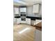Modern kitchen featuring stainless appliances, sleek black countertops, and pristine white cabinets at 1304 E Hackamore St, Mesa, AZ 85203