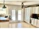 Bright kitchen featuring a ceiling fan, double doors, white cabinets, a wooden breakfast bar and stainless appliances at 1304 E Hackamore St, Mesa, AZ 85203