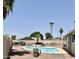 Outdoor pool area with clear blue water and a backyard showing potential for future landscaping at 1304 E Hackamore St, Mesa, AZ 85203