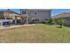 Backyard featuring well-maintained lawn, mature landscaping, and patio at 15040 W Windrose Dr, Surprise, AZ 85379