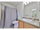 Bathroom featuring a tub with shower, a toilet, and a vanity with sink and mirror at 15040 W Windrose Dr, Surprise, AZ 85379