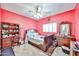 A lovely bedroom featuring a dark wood sleigh bed frame, a ceiling fan, and a classic dresser with mirror at 15040 W Windrose Dr, Surprise, AZ 85379