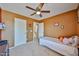 Bedroom with carpet floors, neutral tone walls, window, bed, and access to bathroom at 15040 W Windrose Dr, Surprise, AZ 85379