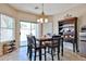 Open dining area featuring a dark wood table and chairs and a sliding glass door providing ample natural light at 15040 W Windrose Dr, Surprise, AZ 85379