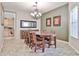 Elegant dining room with a chandelier, large table, and decorative mirror at 15040 W Windrose Dr, Surprise, AZ 85379
