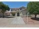 Charming two-story home with a well-maintained front yard and desert landscaping at 15040 W Windrose Dr, Surprise, AZ 85379
