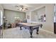 Spacious game room with a pool table, ceiling fan, and unique decor at 15040 W Windrose Dr, Surprise, AZ 85379