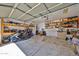 Spacious two car garage with overhead storage, shelving, and motorcycle parking at 15040 W Windrose Dr, Surprise, AZ 85379