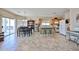 Bright kitchen featuring an island with bar seating, stainless steel appliances, and an adjacent dining area at 15040 W Windrose Dr, Surprise, AZ 85379
