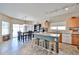 Spacious kitchen featuring an island with seating, stainless steel appliances, and a view into the adjacent dining area at 15040 W Windrose Dr, Surprise, AZ 85379