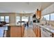 Open kitchen featuring an island with seating, granite countertops, and stainless steel appliances at 15040 W Windrose Dr, Surprise, AZ 85379